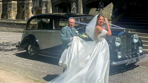 Bride with her father in front of Classic Rolls-Royce in front of Glasgow university.